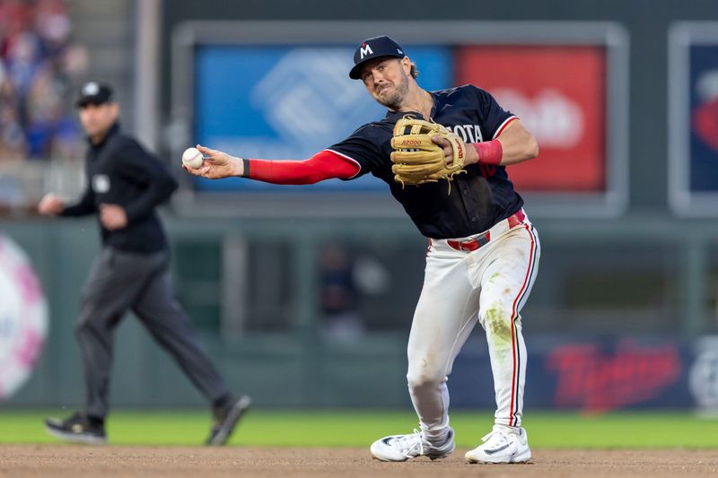 May 14, 2024; Minneapolis, Minnesota, USA; Minnesota Twins third baseman Kyle Farmer (12) throws the ball to first base for an out against the New York Yankees in the fifth inning at Target Field. Mandatory Credit: Jesse Johnson-USA TODAY Sports