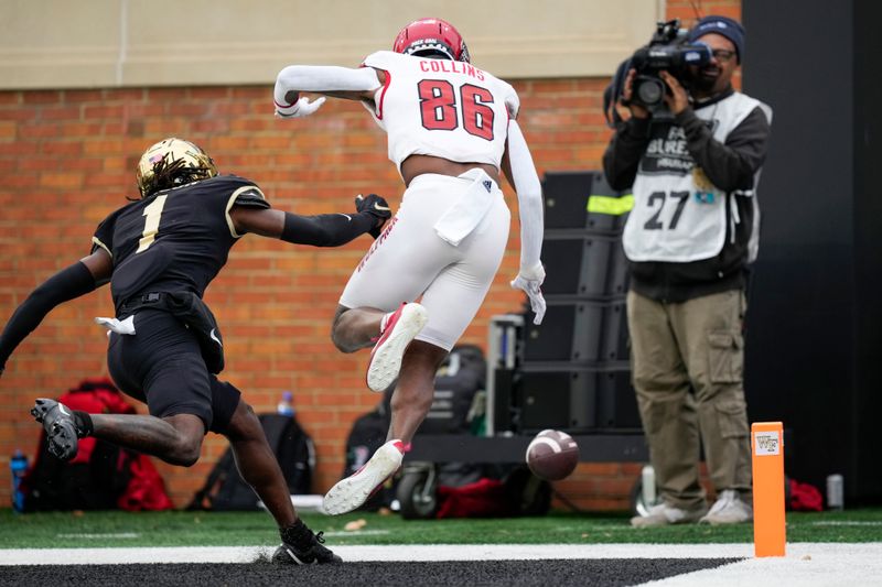 Nov 11, 2023; Winston-Salem, North Carolina, USA; North Carolina State Wolfpack wide receiver Dacari Collins (86) misses a pass broken up by Wake Forest Demon Deacons defensive back Caelen Carson (1) during the second half at Allegacy Federal Credit Union Stadium. Mandatory Credit: Jim Dedmon-USA TODAY Sports