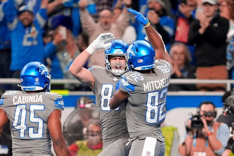 Detroit Lions tight end Sam LaPorta (87) celebrates his touchdown reception with James Mitchell (82) against the Minnesota Vikings in the first half of an NFL football game in Detroit, Sunday, Jan. 7, 2024. (AP Photo/Paul Sancya)