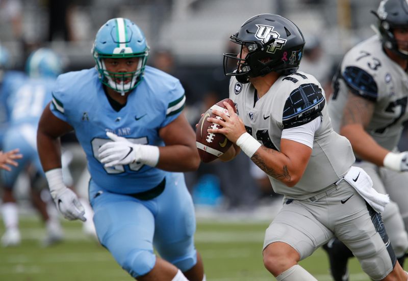 Oct 24, 2020; Orlando, Florida, USA; Tulane Green Wave defensive lineman Adonis Friloux (95) puts pressure on UCF Knights quarterback Dillon Gabriel (11) during the first quarter at the  Bounce House. Mandatory Credit: Reinhold Matay-USA TODAY Sports
