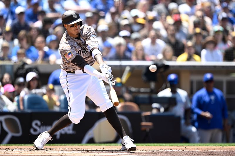 Apr 21, 2024; San Diego, California, USA; San Diego Padres designated hitter Manny Machado (13) hits a single  against the Toronto Blue Jays during the first inning at Petco Park. Mandatory Credit: Orlando Ramirez-USA TODAY Sports