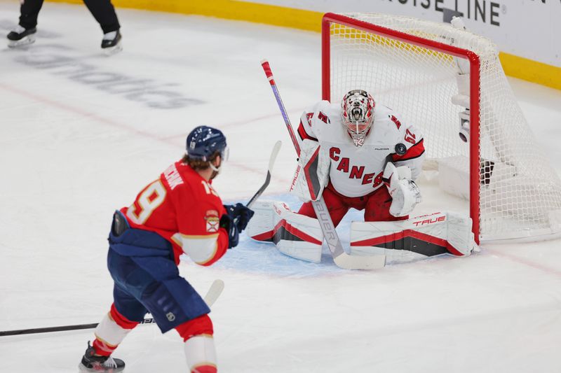 May 24, 2025; Sunrise, Florida, USA; Florida Panthers left wing Matthew Tkachuk (19) takes a shot on goal as Carolina Hurricanes goaltender Pyotr Kochetkov (52) makes a save during the second period in game three of the Eastern Conference Final of the 2025 Stanley Cup Playoffs at Amerant Bank Arena. Mandatory Credit: Sam Navarro-Imagn Images