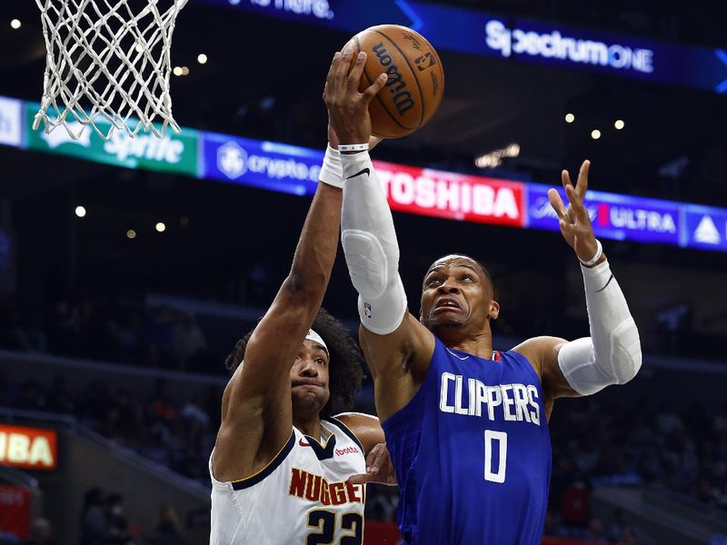 LOS ANGELES, CALIFORNIA - NOVEMBER 27: Russell Westbrook #0 of the LA Clippers takes a shot against Zeke Nnaji #22 of the Denver Nuggets in the second quarter at Crypto.com Arena on November 27, 2023 in Los Angeles, California.  NOTE TO USER: User expressly acknowledges and agrees that, by downloading and/or using this photograph, user is consenting to the terms and conditions of the Getty Images License Agreement. (Photo by Ronald Martinez/Getty Images)