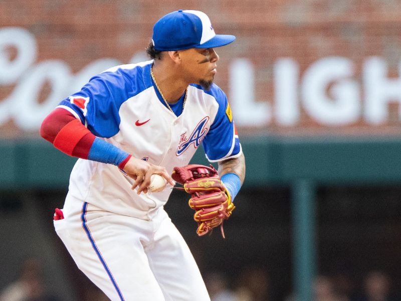 Jun 29, 2024; Cumberland, Georgia, USA; Atlanta Braves shortstop Orlando Arcia (11) fields ground-ball for an out against the Pittsburgh Pirates during the ninth inning at Truist Park. Mandatory Credit: Jordan Godfree-USA TODAY Sports