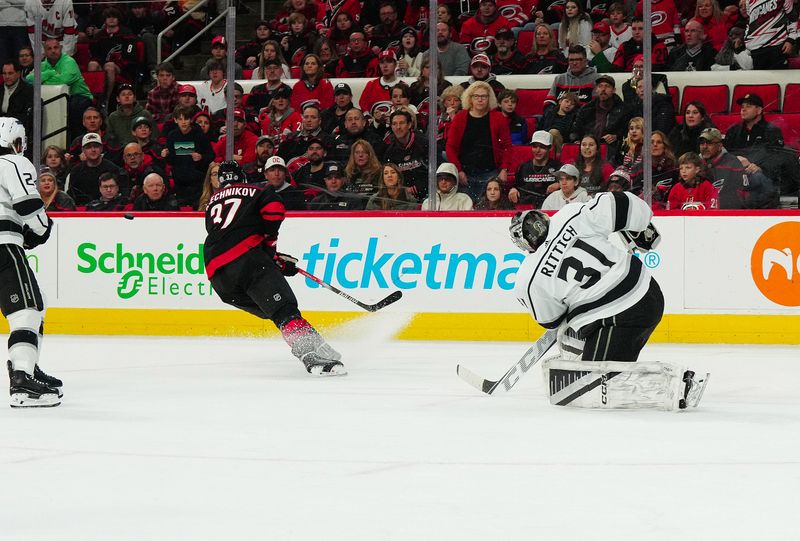 Jan 15, 2024; Raleigh, North Carolina, USA; Los Angeles Kings goaltender David Rittich (31) clears the puck away from Carolina Hurricanes right wing Andrei Svechnikov (37) during the third period at PNC Arena. Mandatory Credit: James Guillory-USA TODAY Sports