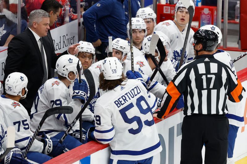 Oct 24, 2023; Washington, District of Columbia, USA; Toronto Maple Leafs head coach Sheldon Keefe (L) challenges a goal by Washington Capitals center Nicklas Backstrom (not pictured) in the first period at Capital One Arena. Mandatory Credit: Geoff Burke-USA TODAY Sports