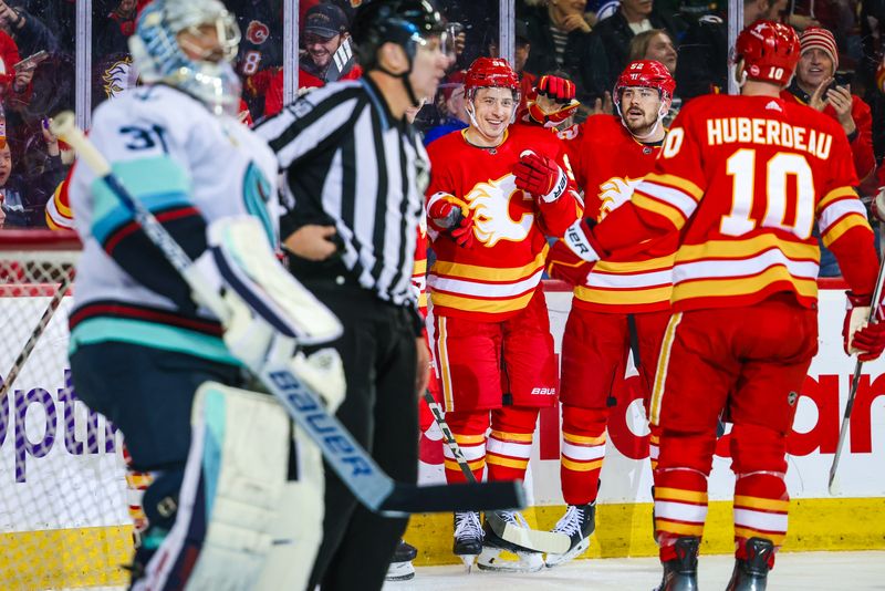 Mar 4, 2024; Calgary, Alberta, CAN; Calgary Flames left wing Andrei Kuzmenko (96) celebrates his goal with teammates against the Seattle Kraken during the second period at Scotiabank Saddledome. Mandatory Credit: Sergei Belski-USA TODAY Sports