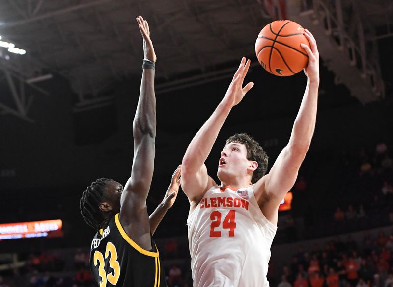 Feb 27, 2024; Clemson, South Carolina, USA; Clemson junior forward PJ Hall (24) shoots the ball near Pitt center Federiko Federiko (33) during the second half at Littlejohn Coliseum. Mandatory Credit: Ken Ruinard-USA TODAY Sports