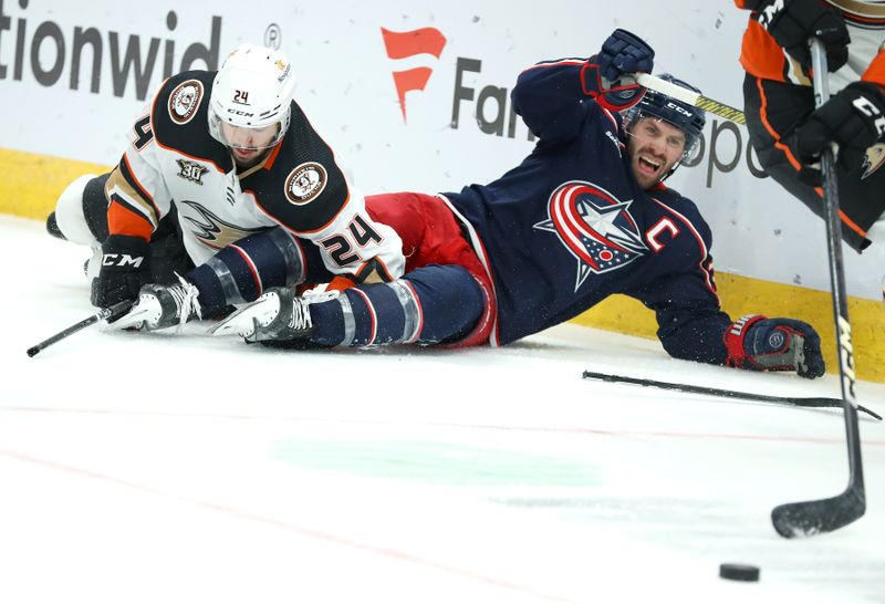 Oct 24, 2023; Columbus, Ohio, USA; Anaheim Ducks center Benoit-Olivier Groulx (24) and Columbus Blue Jackets center Boone Jenner (38) collide while going for the loose puck during the second period at Nationwide Arena. Mandatory Credit: Joseph Maiorana-USA TODAY Sports