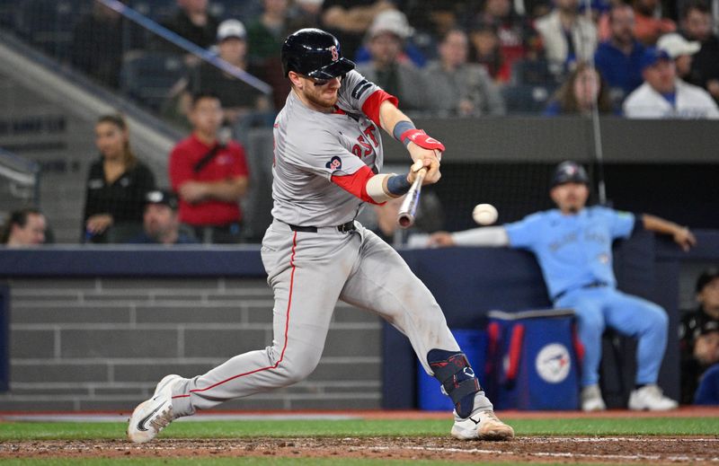 Sep 24, 2024; Toronto, Ontario, CAN;  Boston Red Sox catcher Danny Jansen (28) hits a single against the Toronto Blue Jays in the ninth inning at Rogers Centre. Mandatory Credit: Dan Hamilton-Imagn Images