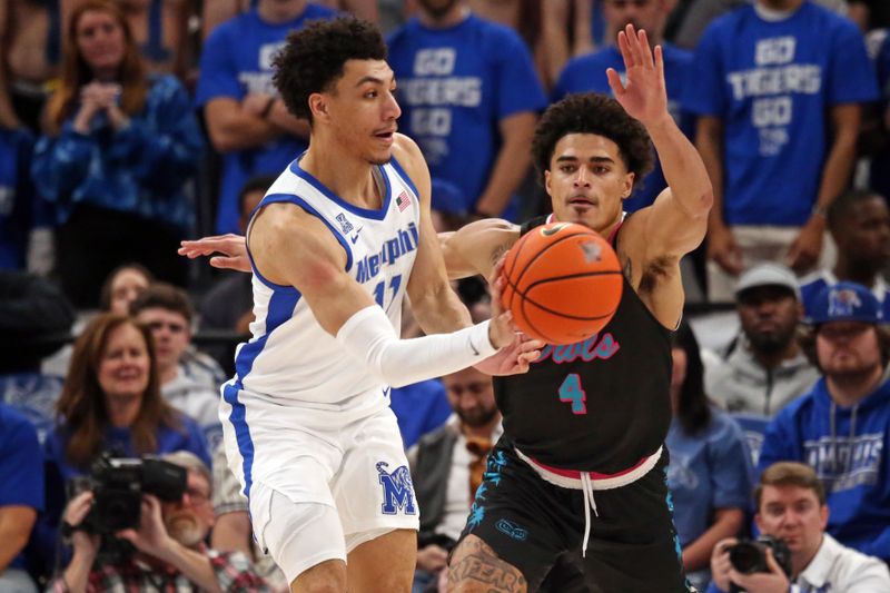 Feb 25, 2024; Memphis, Tennessee, USA; Memphis Tigers guard Jahvon Quinerly (11) passes the ball as Florida Atlantic Owls guard Bryan Greenlee (4) defends during the second half at FedExForum. Mandatory Credit: Petre Thomas-USA TODAY Sports