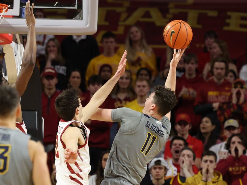 Feb 24, 2024; Ames, Iowa, USA; West Virginia Mountaineers forward Quinn Slazinski (11) shoots over Iowa State Cyclones forward Milan Momcilovic (22) during the first half at James H. Hilton Coliseum. Mandatory Credit: Reese Strickland-USA TODAY Sports