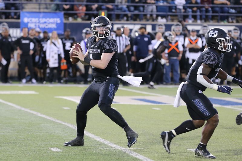 Oct 1, 2021; Logan, Utah, USA; Utah State Aggies quarterback Logan Bonner (1) drops back to pass the ball during the first quarter at Merlin Olsen Field at Maverik Stadium. Mandatory Credit: Rob Gray-USA TODAY Sports