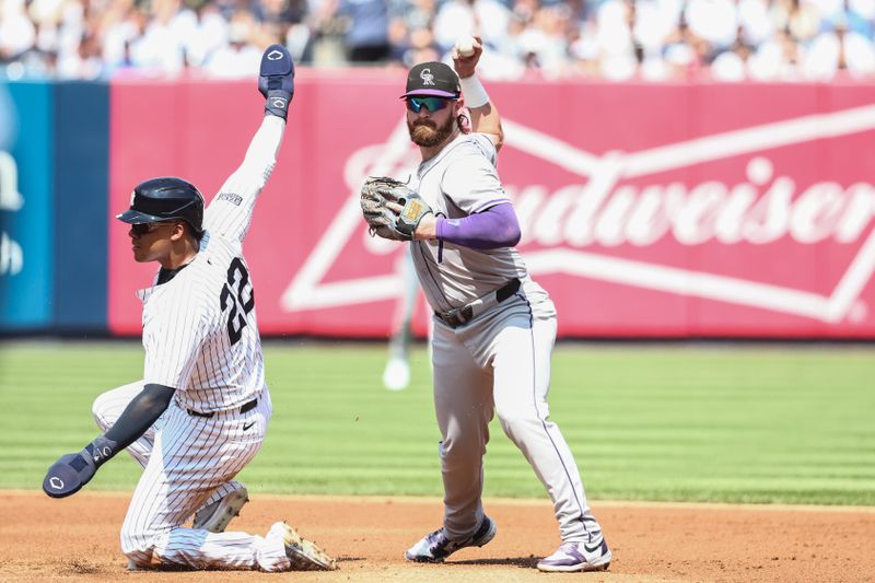 Aug 24, 2024; Bronx, New York, USA;  Colorado Rockies second baseman Brendan Rodgers (7) throws past New York Yankees right fielder Juan Soto (22) attempting to complete a double play in the first inning at Yankee Stadium. Mandatory Credit: Wendell Cruz-USA TODAY Sports