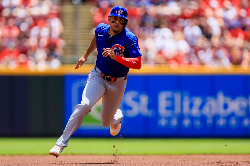 Jun 9, 2024; Cincinnati, Ohio, USA; Chicago Cubs third baseman Christopher Morel (5) scores on a three-run double hit by outfielder Ian Happ (not pictured) in the first inning against the Cincinnati Reds at Great American Ball Park. Mandatory Credit: Katie Stratman-USA TODAY Sports