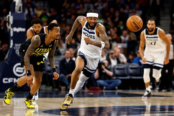 MINNEAPOLIS, MINNESOTA - NOVEMBER 30: Nickeil Alexander-Walker #9 of the Minnesota Timberwolves steals the ball from John Collins #20 of the Utah Jazz in the third quarter at Target Center on November 30, 2023 in Minneapolis, Minnesota. The Timberwolves defeated the Jazz 101-90. NOTE TO USER: User expressly acknowledges and agrees that, by downloading and or using this photograph, User is consenting to the terms and conditions of the Getty Images License Agreement. (Photo by David Berding/Getty Images)