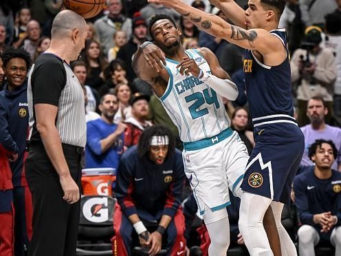 DENVER, CO - JANUARY 1: Michael Porter Jr. (1) of the Denver Nuggets defends Brandon Miller (24) of the Charlotte Hornets during the first quarter at Ball Arena in Denver on Monday, January 1, 2024. (Photo by AAron Ontiveroz/The Denver Post)