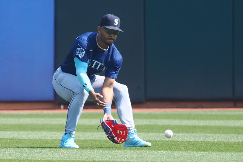 Sep 20, 2023; Oakland, California, USA; Seattle Mariners center fielder Julio Rodriguez (44) fields the ball against the Oakland Athletics during the first inning at Oakland-Alameda County Coliseum. Mandatory Credit: Kelley L Cox-USA TODAY Sports