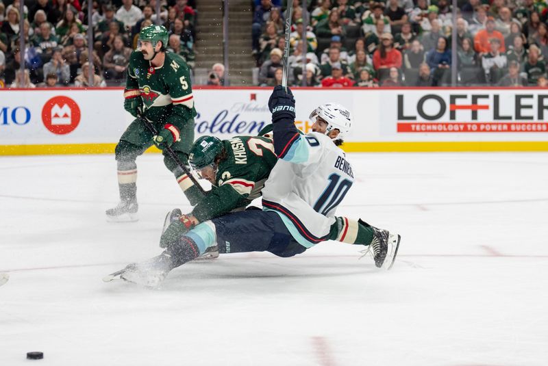 Oct 12, 2024; Saint Paul, Minnesota, USA; Minnesota Wild center Marat Khusnutdinov (22) checks Seattle Kraken center Matty Beniers (10) in front of the net in the third period at Xcel Energy Center. Mandatory Credit: Matt Blewett-Imagn Images