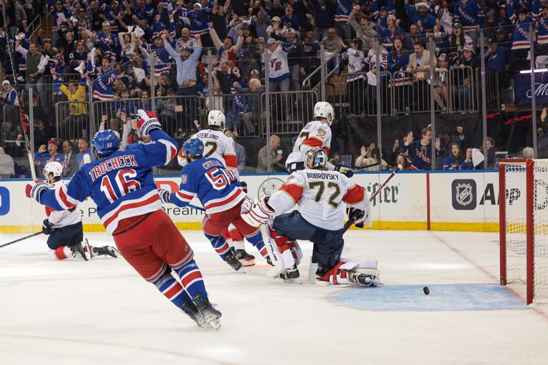 May 24, 2024; New York, New York, USA; New York Rangers center Vincent Trocheck (16) and left wing Will Cuylle (50) celebrate an goal by center Barclay Goodrow (21) against Florida Panthers goaltender Sergei Bobrovsky (72) during overtime in game two of the Eastern Conference Final of the 2024 Stanley Cup Playoffs at Madison Square Garden. Mandatory Credit: Vincent Carchietta-USA TODAY Sports