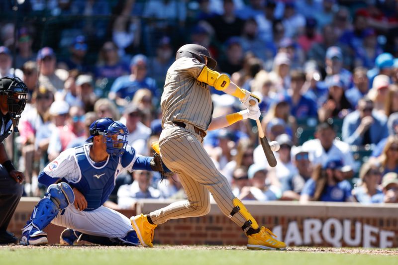 May 8, 2024; Chicago, Illinois, USA; San Diego Padres first base Jake Cronenworth (9) hits an RBI-double against the Chicago Cubs during the fifth inning at Wrigley Field. Mandatory Credit: Kamil Krzaczynski-USA TODAY Sports