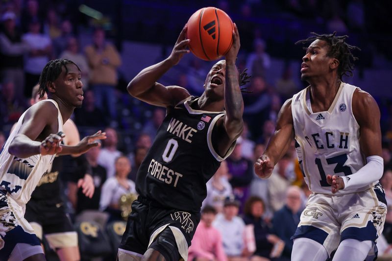 Feb 6, 2024; Atlanta, Georgia, USA; Wake Forest Demon Deacons guard Kevin Miller (0) shoots past Georgia Tech Yellow Jackets forward Baye Ndongo (11) and guard Miles Kelly (13) in the first half at McCamish Pavilion. Mandatory Credit: Brett Davis-USA TODAY Sports