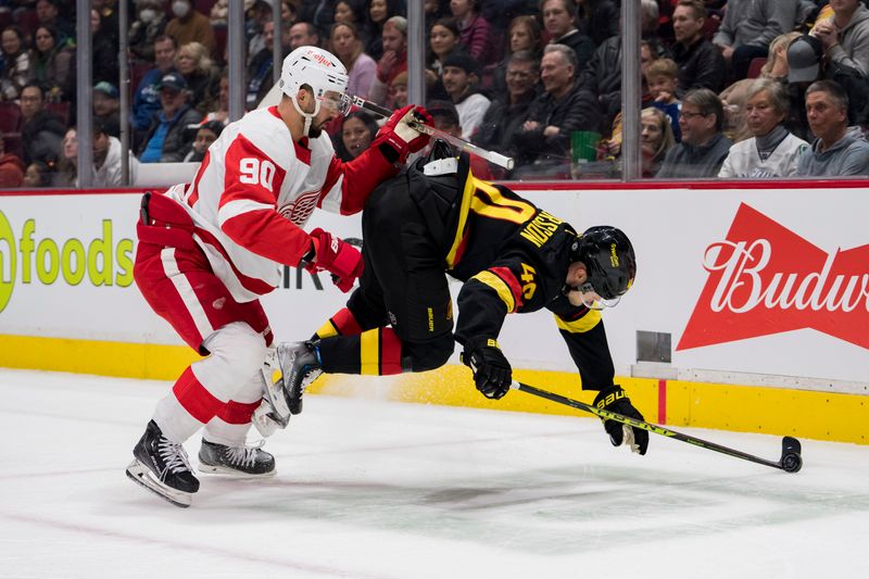 Feb 13, 2023; Vancouver, British Columbia, CAN; Detroit Red Wings forward Joe Veleno (90) checks Vancouver Canucks forward Elias Pettersson (40) in the first period at Rogers Arena. Mandatory Credit: Bob Frid-USA TODAY Sports