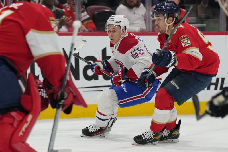 Dec 30, 2023; Sunrise, Florida, USA;  Florida Panthers left wing Ryan Lomberg (94) defends Montreal Canadiens right wing Jesse Ylonen (56) during the first period at Amerant Bank Arena. Mandatory Credit: Jim Rassol-USA TODAY Sports