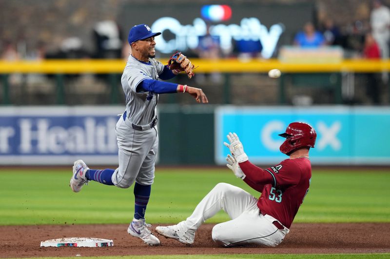 Apr 29, 2024; Phoenix, Arizona, USA; Los Angeles Dodgers second baseman Mookie Betts (50) throws to first base after forcing out Arizona Diamondbacks first base Christian Walker (53) at second base during the third inning at Chase Field. Mandatory Credit: Joe Camporeale-USA TODAY Sports