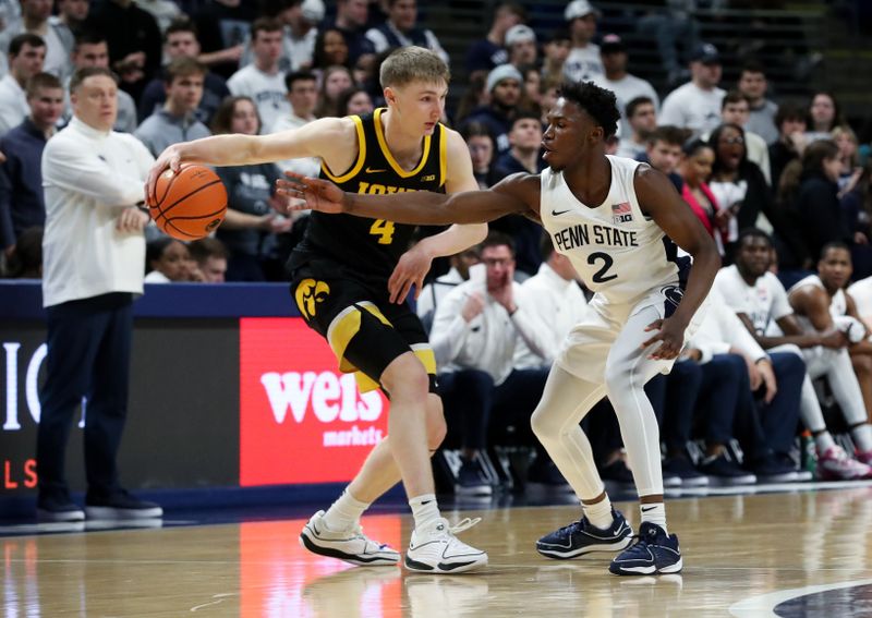 Feb 8, 2024; University Park, Pennsylvania, USA; Penn State Nittany Lions guard D'Marco Dunn (2) attempts to steal the ball from Iowa Hawkeyes guard Josh Dix (4) during the first half at Bryce Jordan Center. Penn State defeated Iowa 89-79. Mandatory Credit: Matthew O'Haren-USA TODAY Sports