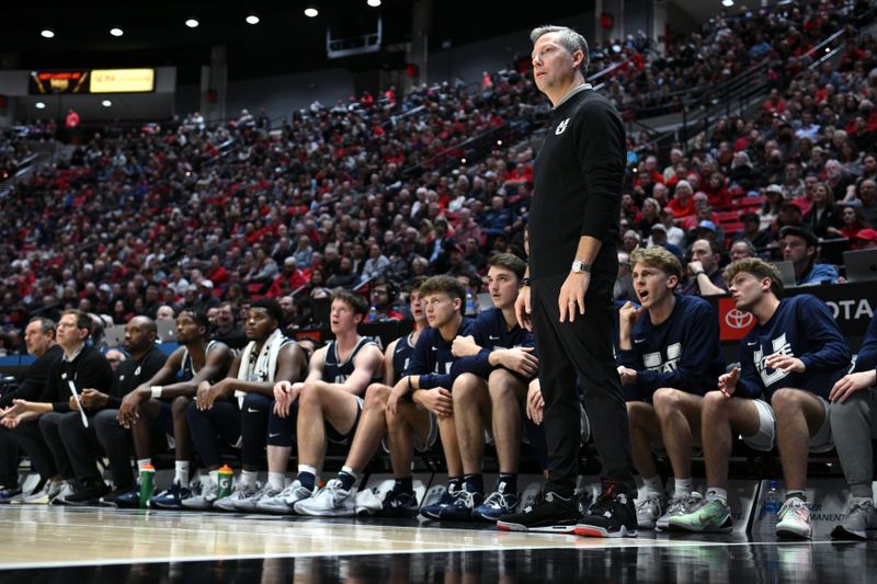 Jan 25, 2023; San Diego, California, USA; Utah State Aggies head coach Ryan Odom (front) looks on from the sideline during the first half against the San Diego State Aztecs at Viejas Arena. Mandatory Credit: Orlando Ramirez-USA TODAY Sports