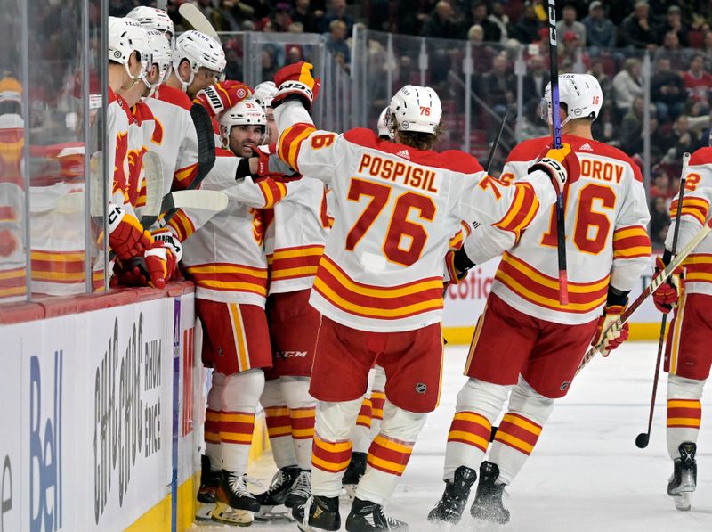 Nov 14, 2023; Montreal, Quebec, CAN; Calgary Flames forward Nazem Kadri (91) celebrates with teammates after scoring a goal against the Montreal Canadiens during the second period at the Bell Centre. Mandatory Credit: Eric Bolte-USA TODAY Sports