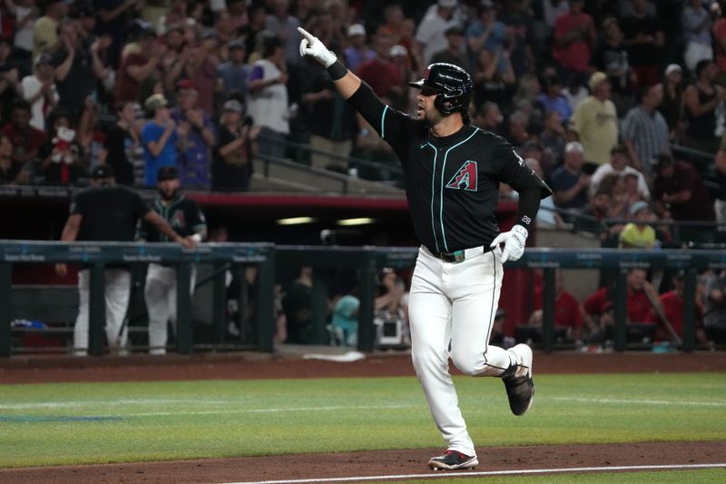 Aug 14, 2024; Phoenix, Arizona, USA; Arizona Diamondbacks third base Eugenio Suarez (28) reacts after hitting a grand slam against the Colorado Rockies in the sixth inning at Chase Field. Mandatory Credit: Rick Scuteri-USA TODAY Sports