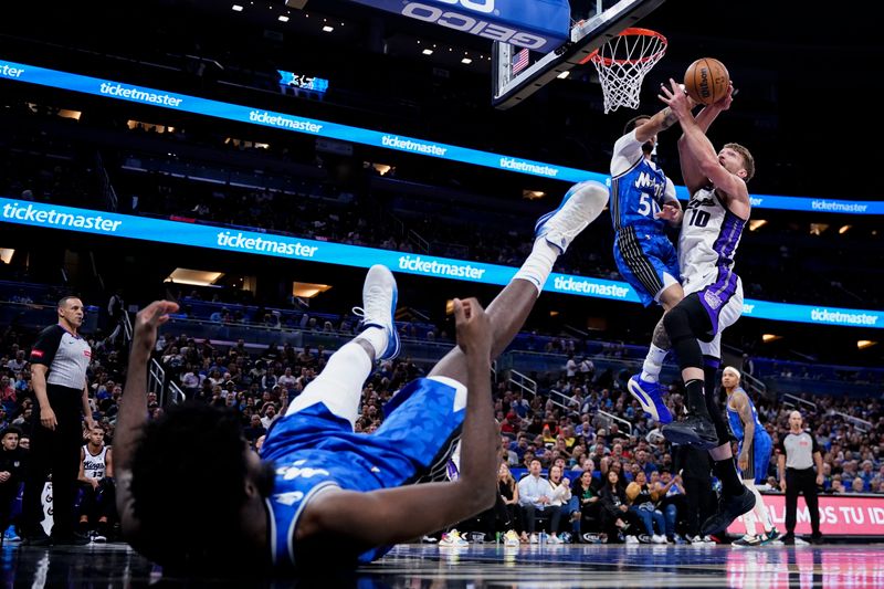 ORLANDO, FLORIDA - MARCH 23: Cole Anthony #50 of the Orlando Magic blocks the shot of Domantas Sabonis #10 of the Sacramento Kings during the first quarter at Kia Center on March 23, 2024 in Orlando, Florida. NOTE TO USER: User expressly acknowledges and agrees that, by downloading and or using this photograph, User is consenting to the terms and conditions of the Getty Images License Agreement. (Photo by Rich Storry/Getty Images)