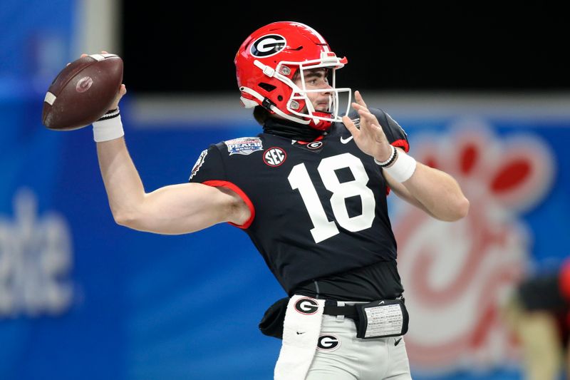 Jan 1, 2021; Atlanta, GA, USA; Georgia Bulldogs quarterback JT Daniels (18) warms up prior to the Chick-fil-A Peach Bowl against the Cincinnati Bearcats at Mercedes-Benz Stadium. Mandatory Credit: Brett Davis-USA TODAY Sports
