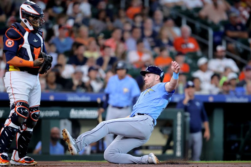 Jul 30, 2023; Houston, Texas, USA; Tampa Bay Rays left fielder Luke Raley (55) slides home to score a run against the Houston Astros during the first inning at Minute Maid Park. Mandatory Credit: Erik Williams-USA TODAY Sports