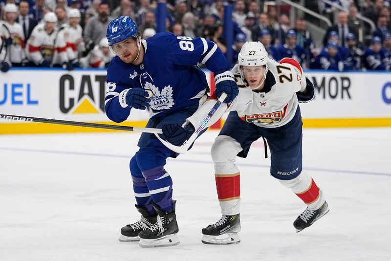 May 5, 2025; Toronto, Ontario, CAN; Toronto Maple Leafs forward William Nylander (88) and Florida Panthers forward Eetu Luostarinen (27) battle for position during the third period of the second round of the 2025 Stanley Cup Playoffs at Scotiabank Arena. Mandatory Credit: John E. Sokolowski-Imagn Images