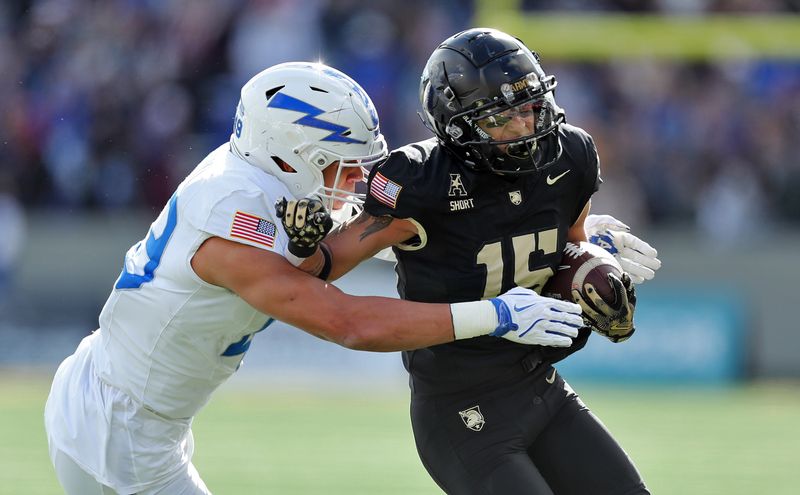 Nov 2, 2024; West Point, New York, USA; Army Black Knights running back Noah Short (15) tries to get by Air Force Falcons safety Houston Hendrix (19) during the first half at Michie Stadium. Mandatory Credit: Danny Wild-Imagn Images