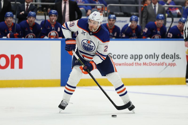 Mar 14, 2025; Elmont, New York, USA; Edmonton Oilers center Leon Draisaitl (29) controls the puck against the New York Islanders during the third period at UBS Arena. Mandatory Credit: Thomas Salus-Imagn Images