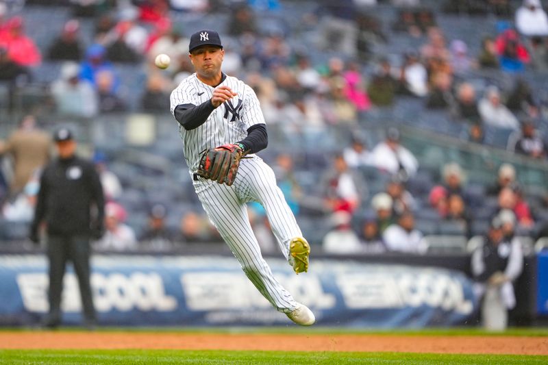 Apr 5, 2023; Bronx, New York, USA; New York Yankees shortstop Isiah Kiner-Falefa (12) attempts to throw out Philadelphia Phillies shortstop Trea Turner (7) (not pictured) during the third inning at Yankee Stadium. Mandatory Credit: Gregory Fisher-USA TODAY Sports