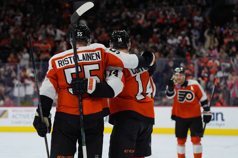 Nov 23, 2024; Philadelphia, Pennsylvania, USA; Philadelphia Flyers center Sean Couturier (14) celebrates with defenseman Rasmus Ristolainen (55) after scoring a goal against the Chicago Blackhawks in the third period at Wells Fargo Center. Mandatory Credit: Kyle Ross-Imagn Images