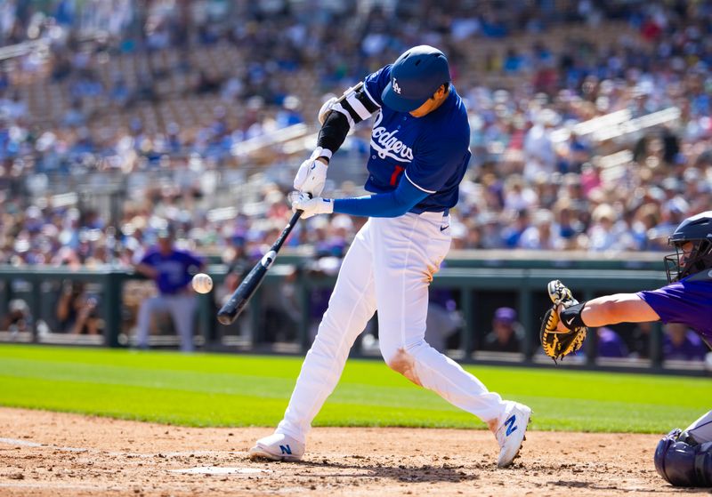 Mar 3, 2024; Phoenix, Arizona, USA; Los Angeles Dodgers designated hitter Shohei Ohtani hits a triple against the Colorado Rockies during a spring training game at Camelback Ranch-Glendale. Mandatory Credit: Mark J. Rebilas-USA TODAY Sports