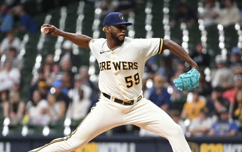 May 23, 2023; Milwaukee, Wisconsin, USA; Milwaukee Brewers relief pitcher Elvis Peguero (59) delivers a pitch against the Houston Astros in the seventh inning at American Family Field. Mandatory Credit: Michael McLoone-USA TODAY Sports