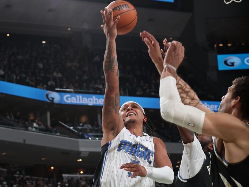 MILWAUKEE, WI - JANUARY 15: Paolo Banchero #5 of the Orlando Magic drives to the basket during the game against the Milwaukee Bucks on January 15, 2025 at Fiserv Forum Center in Milwaukee, Wisconsin. NOTE TO USER: User expressly acknowledges and agrees that, by downloading and or using this Photograph, user is consenting to the terms and conditions of the Getty Images License Agreement. Mandatory Copyright Notice: Copyright 2025 NBAE (Photo by Gary Dineen/NBAE via Getty Images).