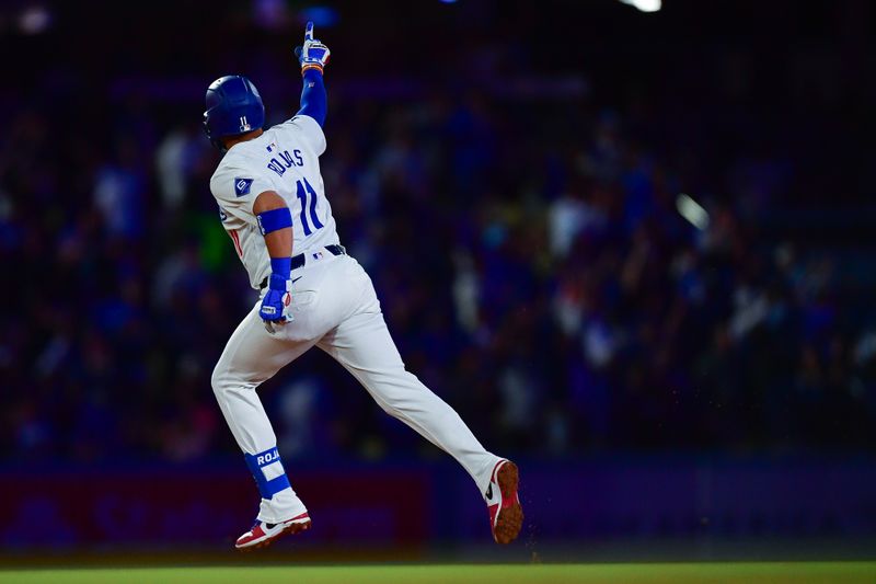 Apr 3, 2024; Los Angeles, California, USA; Los Angeles Dodgers shortstop Miguel Rojas (11) rounds the bases after hitting a solo home run against the San Francisco Giants during the fourth inning at Dodger Stadium. Mandatory Credit: Gary A. Vasquez-USA TODAY Sports