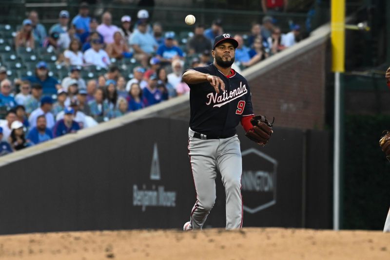 Jul 17, 2023; Chicago, Illinois, USA;  Washington Nationals third baseman Jeimer Candelario (9) throws Chicago Cubs right fielder Seiya Suzuki (27) out at first base during the first inning at Wrigley Field. Mandatory Credit: Matt Marton-USA TODAY Sports