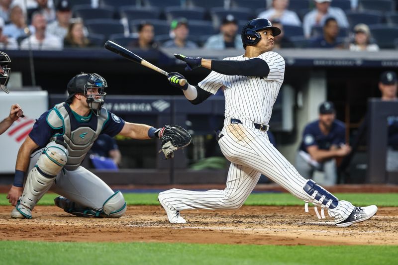 May 22, 2024; Bronx, New York, USA;  New York Yankees right fielder Juan Soto (22) hits a two-run home run in the third inning against the Seattle Mariners at Yankee Stadium. Mandatory Credit: Wendell Cruz-USA TODAY Sports