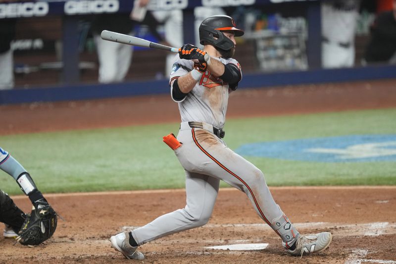 Jul 24, 2024; Miami, Florida, USA;  Baltimore Orioles left fielder Colton Cowser (17) hits a three-run double in the sixth inning against the Miami Marlins at loanDepot Park. Mandatory Credit: Jim Rassol-USA TODAY Sports