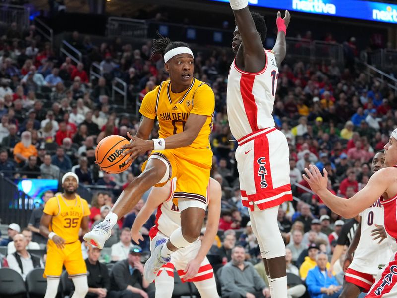 Mar 10, 2023; Las Vegas, NV, USA; Arizona State Sun Devils guard DJ Horne (0) looks to make a pass around Arizona Wildcats center Oumar Ballo (11) during the first half at T-Mobile Arena. Mandatory Credit: Stephen R. Sylvanie-USA TODAY Sports