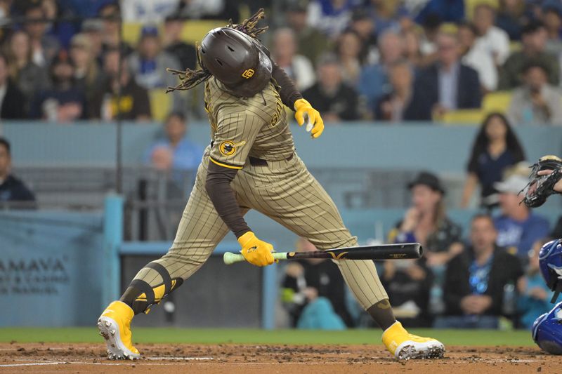 Sep 26, 2024; Los Angeles, California, USA;  San Diego Padres right fielder Fernando Tatis Jr. (23) backs off an inside pitch in the fourth inning against the Los Angeles Dodgers at Dodger Stadium. Mandatory Credit: Jayne Kamin-Oncea-Imagn Images